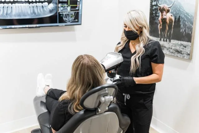 Dentist speaking with a patient during an urgent visit